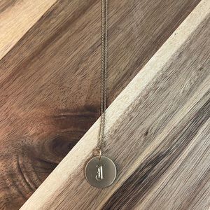Gold plated necklace with the letter “J” engraved.